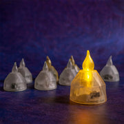 One amber LED diya in focus, with several blurred clear diyas in the background against a purple backdrop.