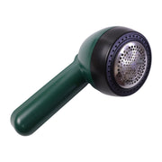 A dark green and black lint remover with a silver mesh head is angled on a white background.