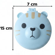 A light blue round folding hairbrush, closed, features a cartoon bear face with black eyes and nose, and tan stripes, with