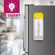A white and yellow plastic bag dispenser with clear bags inside is mounted on the side of a stainless steel refrigerator.