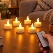 Six white LED flameless candles glowing on a wooden table with a hand holding a remote control.