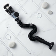 Close-up shot of flexible sink drain pipe being installed in bathroom