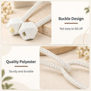 Close-up of the white geometric plastic buckle design and the braided polyester rope of the tieback.