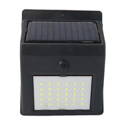 Front view of the black solar-powered wall light with 30 LEDs, featuring a solar panel on top and a motion sensor below.