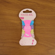 A pink package of 'Princesse Lili' hair bands, labeled 'Super Doux' and 'Super Soft', sits on a wooden surface.