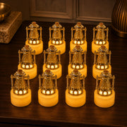 Twelve miniature gold lantern LED candles arranged in a grid on a dark wooden surface, emitting a warm glow.