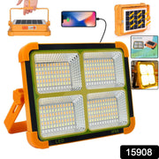 Orange and black solar LED flood light with four illuminated panels, shown with a phone charging and solar panel detail.