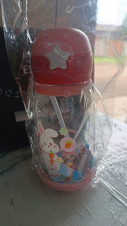 A pink and clear water bottle with a bunny design, deer antlers, and a strap, wrapped in clear plastic.