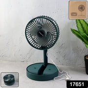 A dark green telescopic foldable mini USB desk fan with a white USB cable on a grey surface, with packaging details.