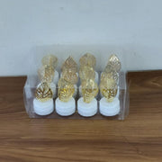Romantic setting with golden leaf shaped flameless LED candle lighting creating a serene atmosphere.