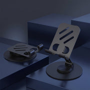 Two black metal mobile stands, one folded flat and one upright, on dark blue geometric blocks.
