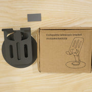 A black metal mobile stand next to its brown cardboard box labeled 