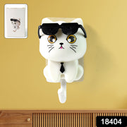 White cat-shaped wall hook with sunglasses and a tie on a yellow wall, with an inset showing packaging.