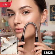 A woman holds a silver spring facial hair remover to her cheek, with a 