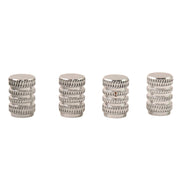 Four silver, textured, cylindrical valve caps standing upright on a white background.